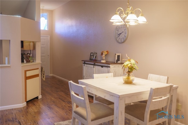 dining room with a notable chandelier and dark hardwood / wood-style flooring