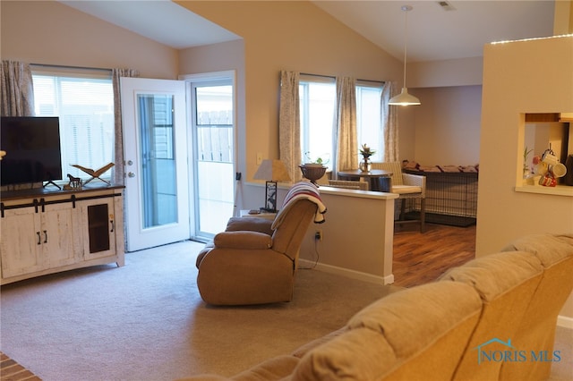 living room with carpet floors and vaulted ceiling