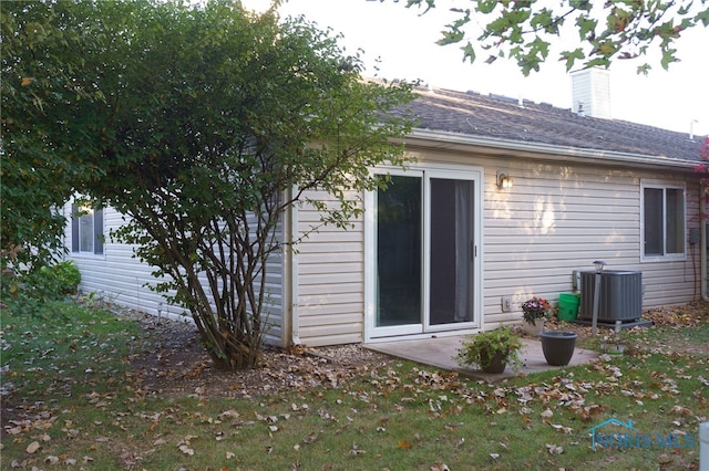 rear view of property with central AC