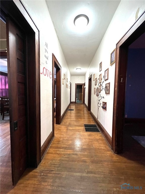 hallway with wood-type flooring