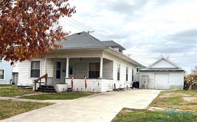 bungalow featuring covered porch and a storage shed