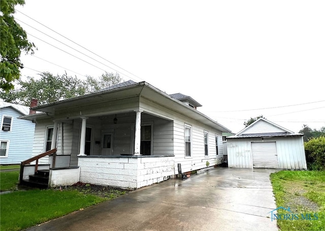 213 E Johnson St, Upper Sandusky, OH 43351 - view of property exterior with driveway, an outdoor structure, a garage, and a porch