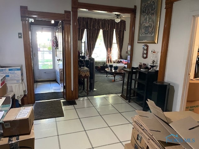 entryway featuring ceiling fan and light tile patterned flooring