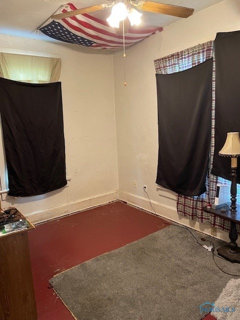 unfurnished bedroom featuring dark carpet and ceiling fan