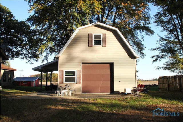 rear view of property with a garage