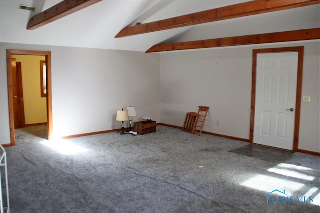 carpeted spare room featuring vaulted ceiling with beams