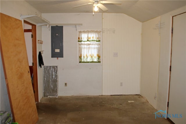 unfurnished room featuring electric panel, concrete flooring, ceiling fan, and vaulted ceiling