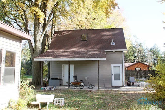 back of property with a patio