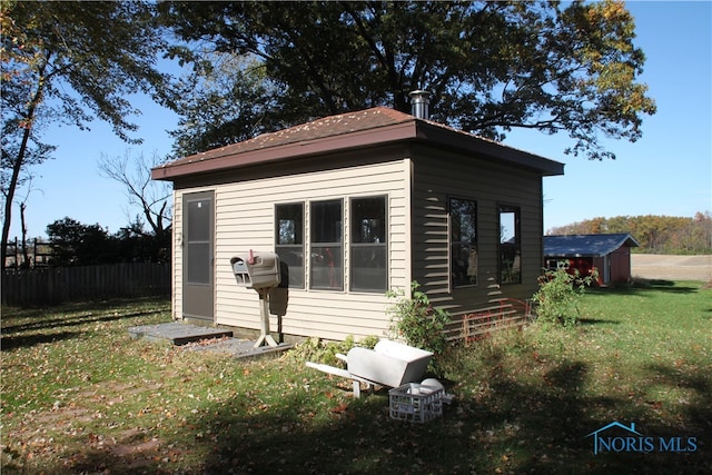 exterior space with an outbuilding and a yard