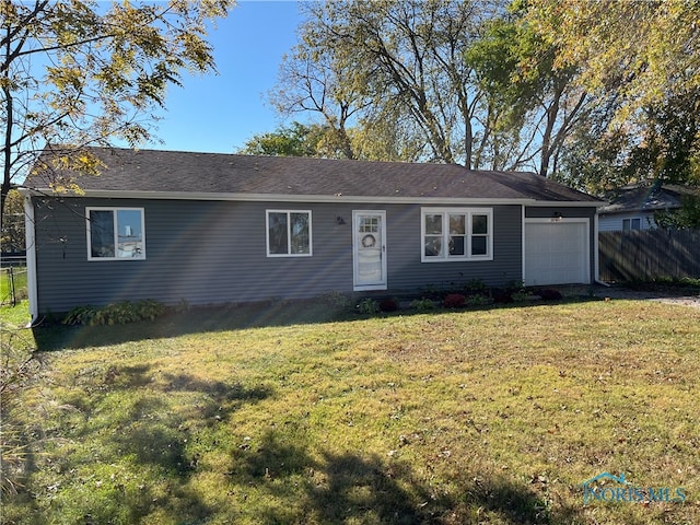 ranch-style home with a garage and a front lawn