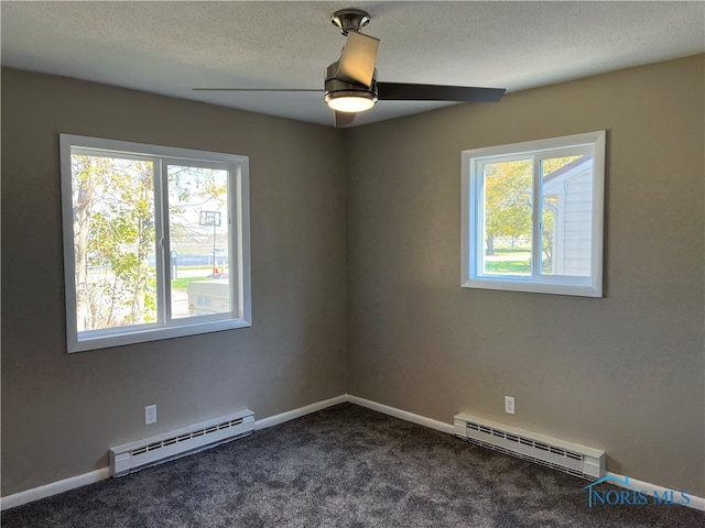 unfurnished room with a textured ceiling, a baseboard heating unit, and carpet floors