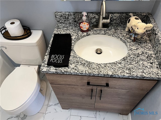 bathroom with toilet and vanity