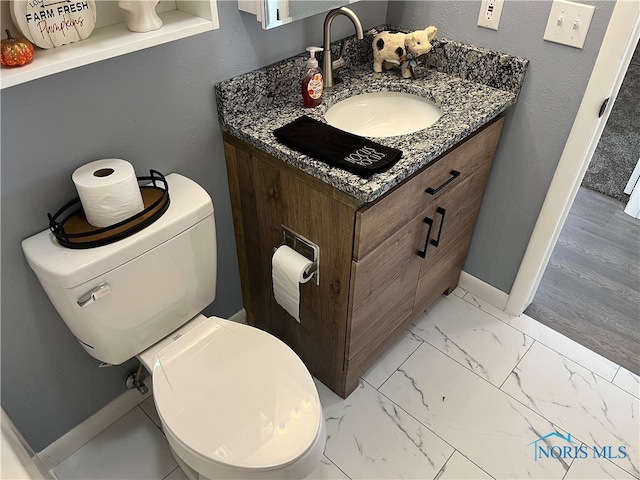 bathroom with vanity and toilet