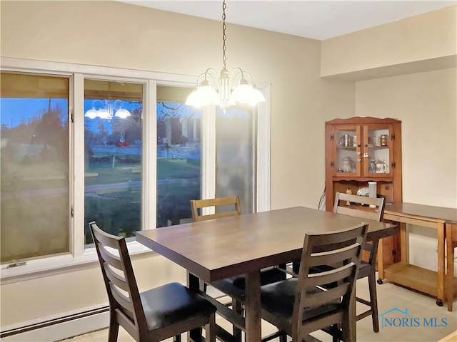 dining room with a baseboard radiator and a notable chandelier