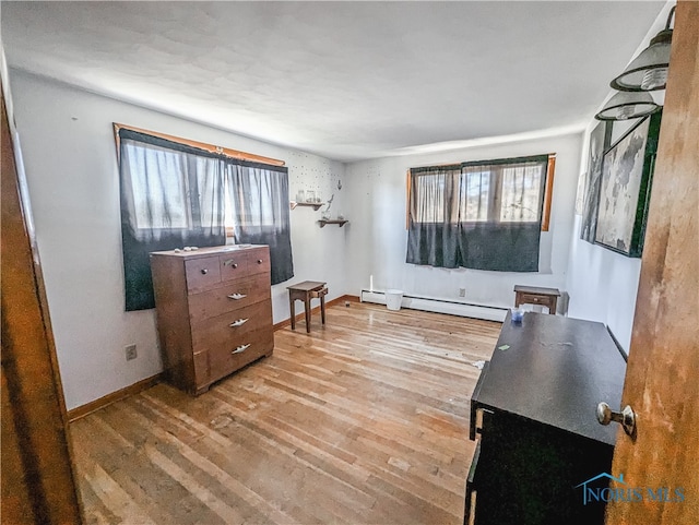 interior space with light hardwood / wood-style floors and a baseboard heating unit