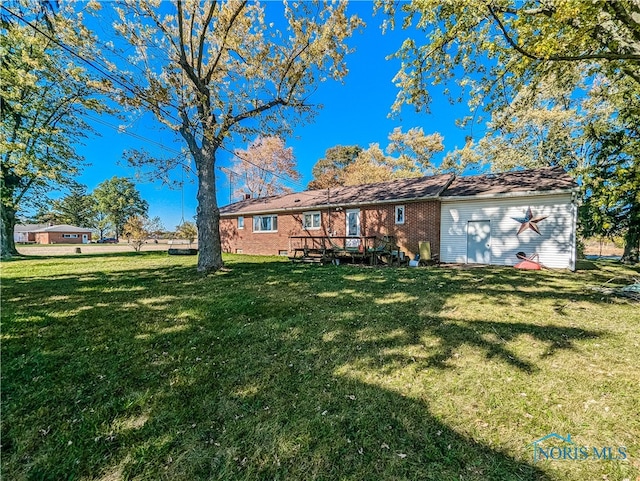 rear view of house with a yard