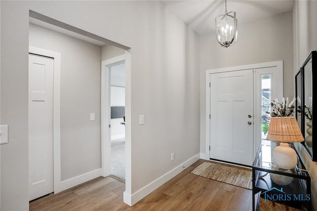 foyer with a chandelier and light wood-type flooring