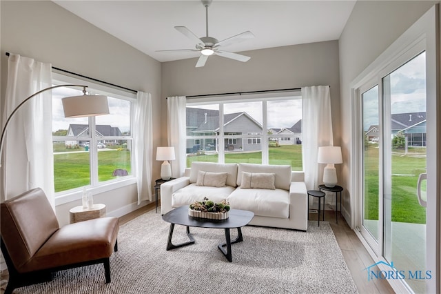 sunroom / solarium featuring ceiling fan