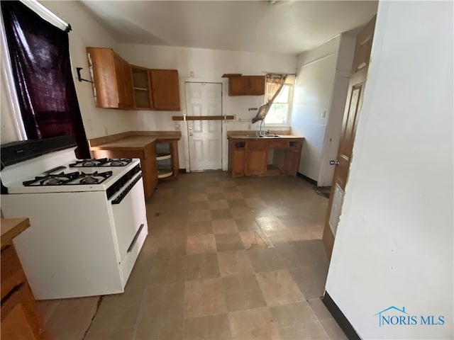 kitchen with sink and white gas range