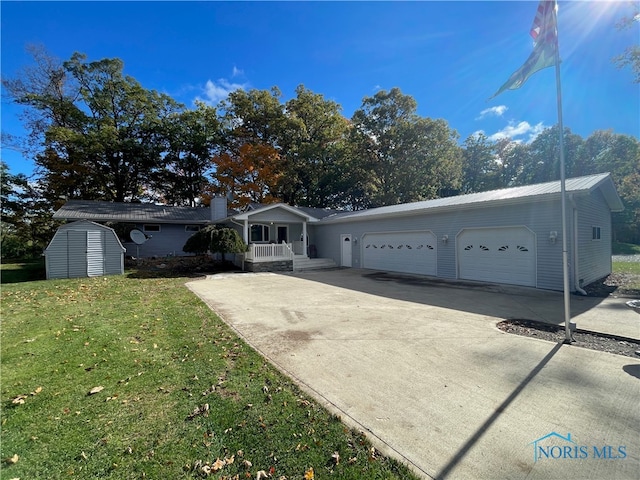 ranch-style house with a shed, a front lawn, and a garage