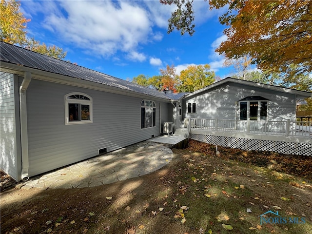 rear view of house featuring a patio area and a deck