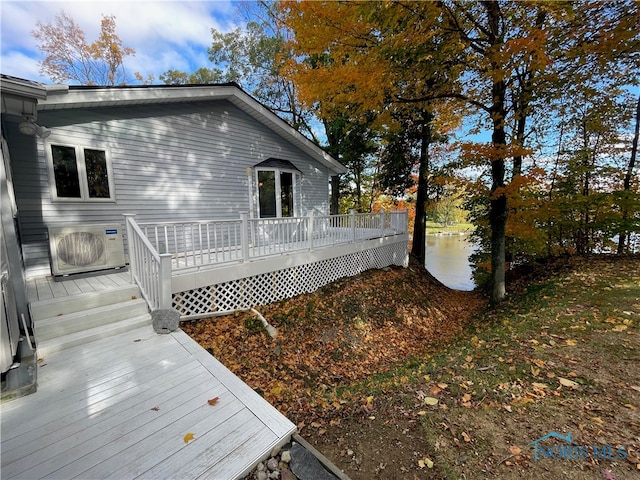 back of property with ac unit and a deck