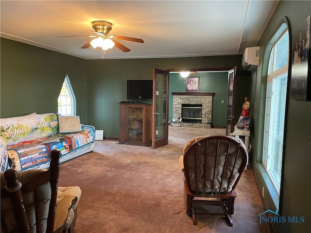 living room featuring carpet floors, a brick fireplace, ceiling fan, crown molding, and a wall mounted AC