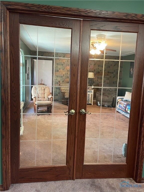 entryway featuring french doors, carpet floors, and ceiling fan