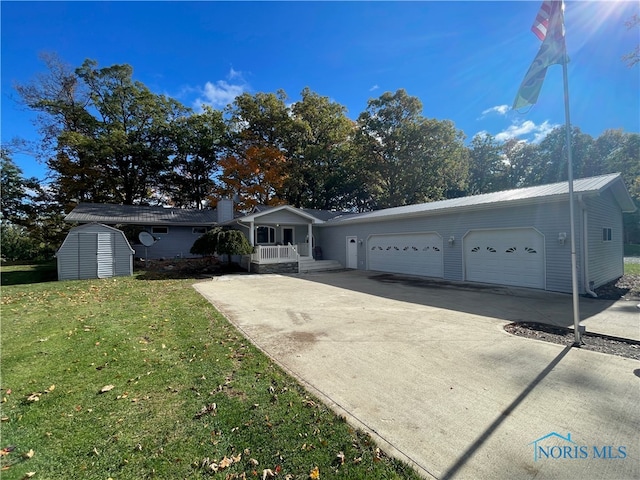 single story home featuring a front yard, a storage shed, and a garage