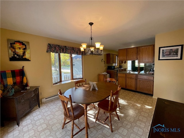 dining room with an inviting chandelier and a baseboard heating unit