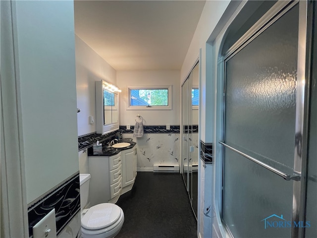 bathroom with vanity, baseboard heating, a shower with shower door, and toilet