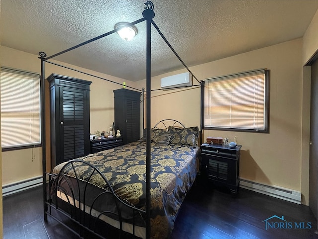 bedroom featuring dark wood-type flooring, a baseboard heating unit, a wall mounted air conditioner, and a textured ceiling