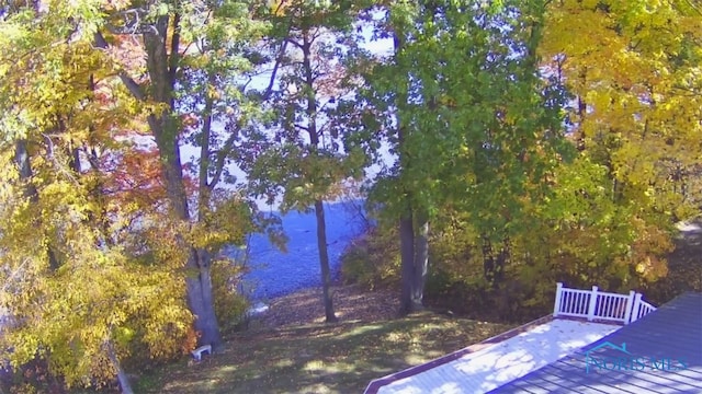 view of yard with a deck with water view