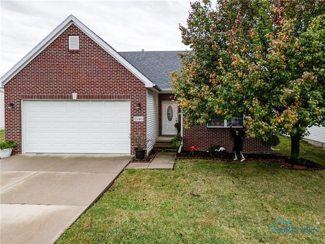 view of front of property with a front lawn and a garage