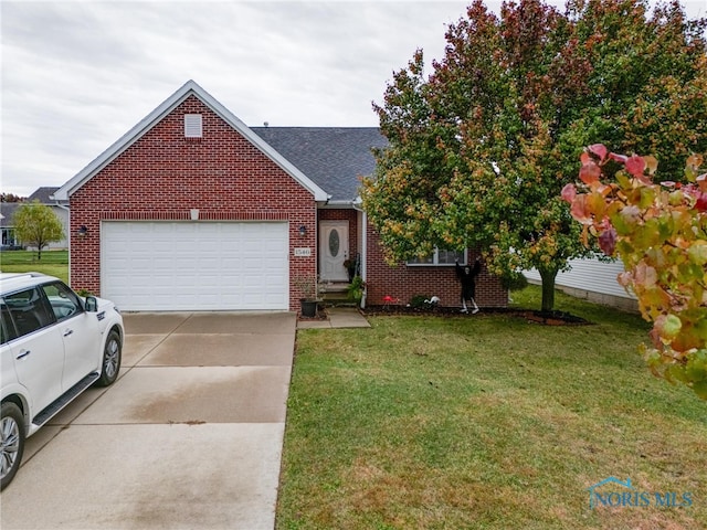 view of front of property featuring a front yard and a garage