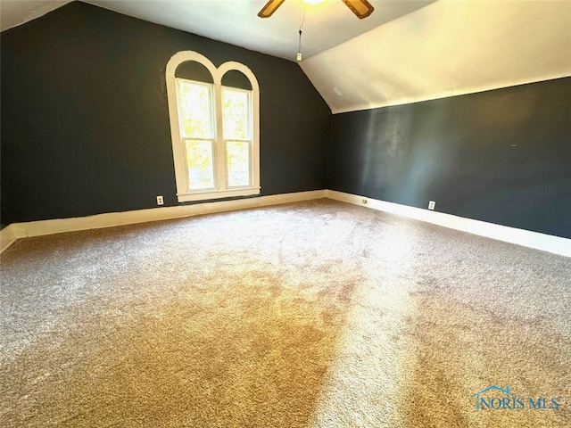 additional living space featuring carpet, vaulted ceiling, and ceiling fan