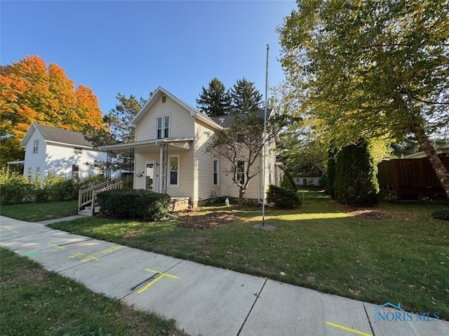 view of front of property with covered porch and a front lawn