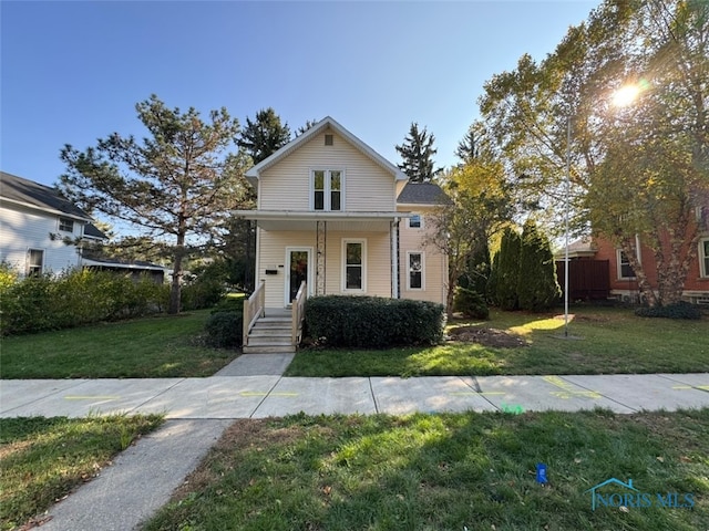 view of front of home featuring a front yard and covered porch