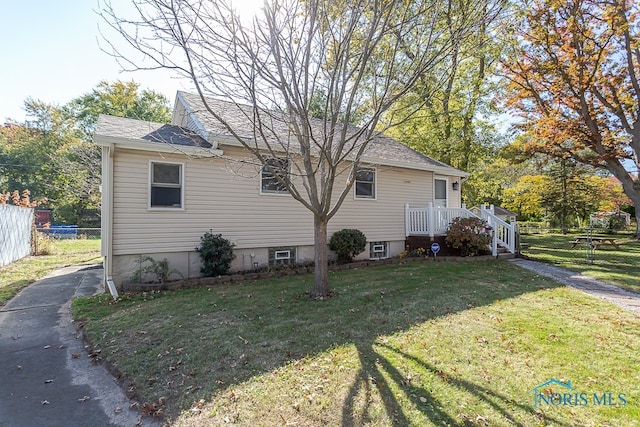 view of property exterior with a lawn