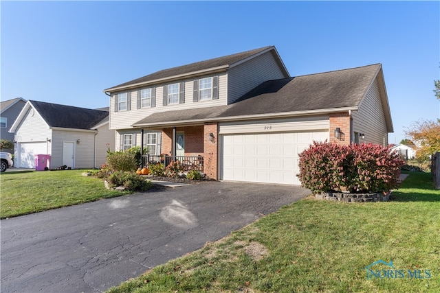 view of front of house with a front lawn and a garage