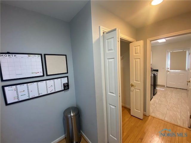 hallway with light hardwood / wood-style flooring