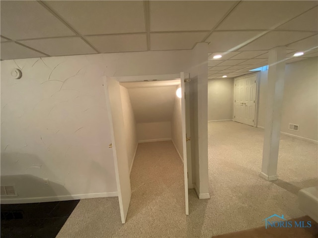 basement featuring carpet and a drop ceiling