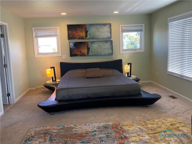 bedroom featuring light carpet