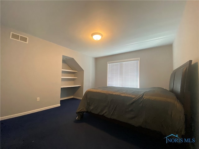 bedroom featuring dark colored carpet