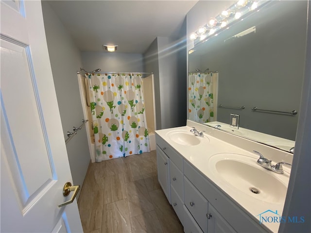 bathroom featuring vanity and shower / bath combination with curtain