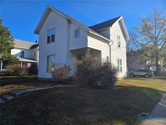 view of property exterior featuring a lawn