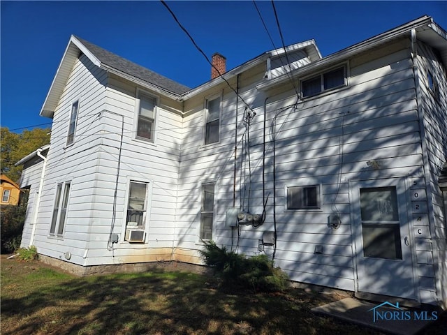 502 N Prospect St, Bowling Green, OH 43402 - view of home's exterior with a chimney and cooling unit