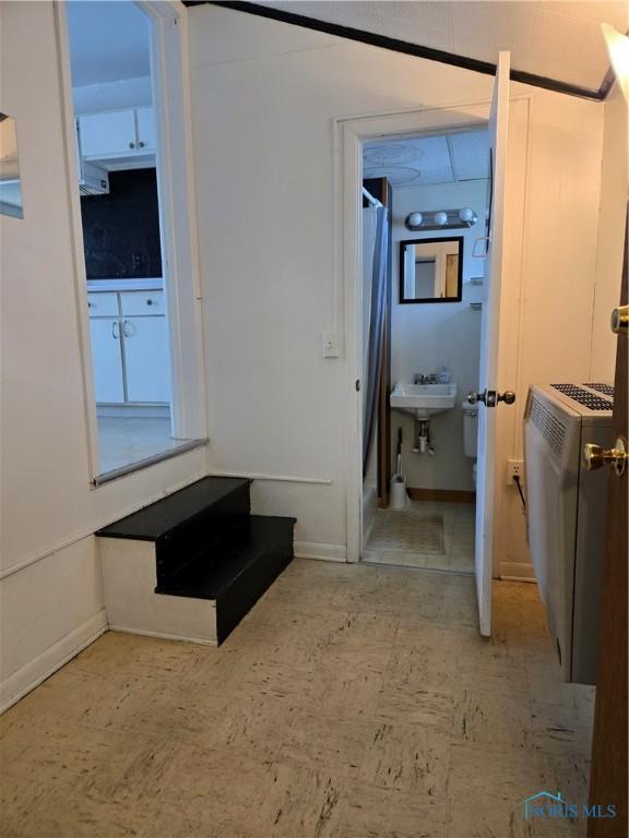 502 N Prospect St, Bowling Green, OH 43402 - corridor with light flooring, baseboards, and a sink