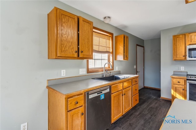 kitchen with dark hardwood / wood-style floors, stainless steel appliances, and sink