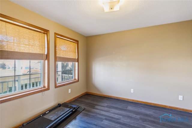 exercise area with dark hardwood / wood-style flooring